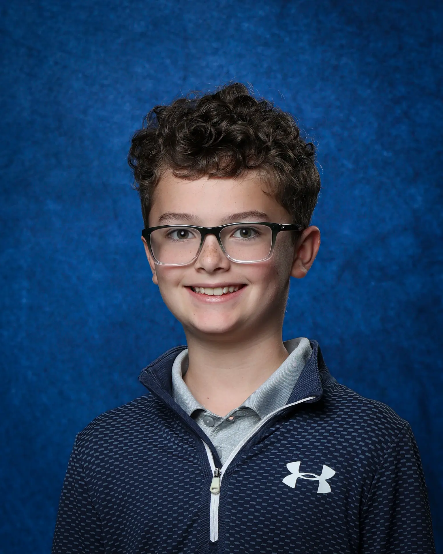 Student portrait on a classic blue backdrop